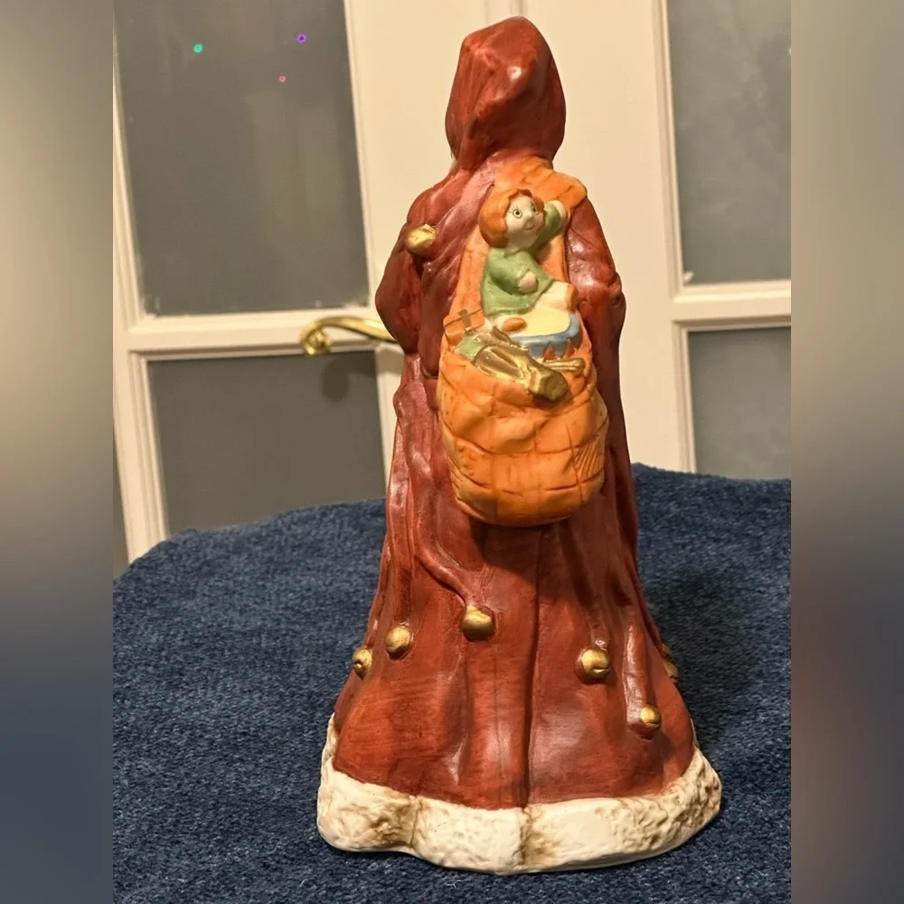 Incredible porcelain Santa carries his pack& wears a brownish robe.